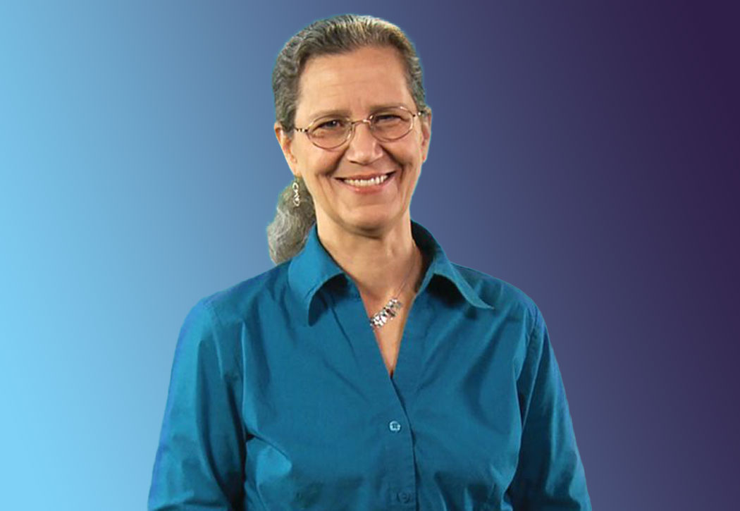 Woman smiling with blue shirt and blue and purple background