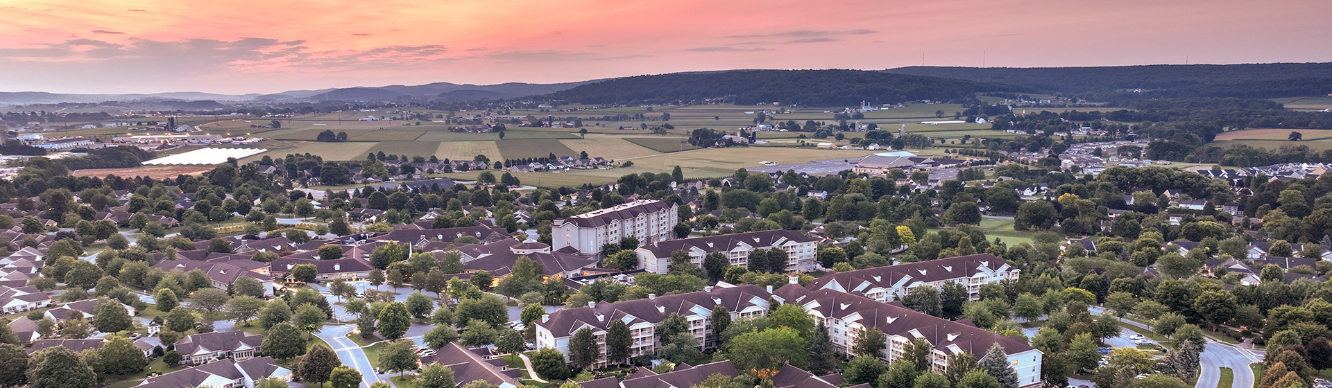 an aerial view of a residential area with mountains in the background